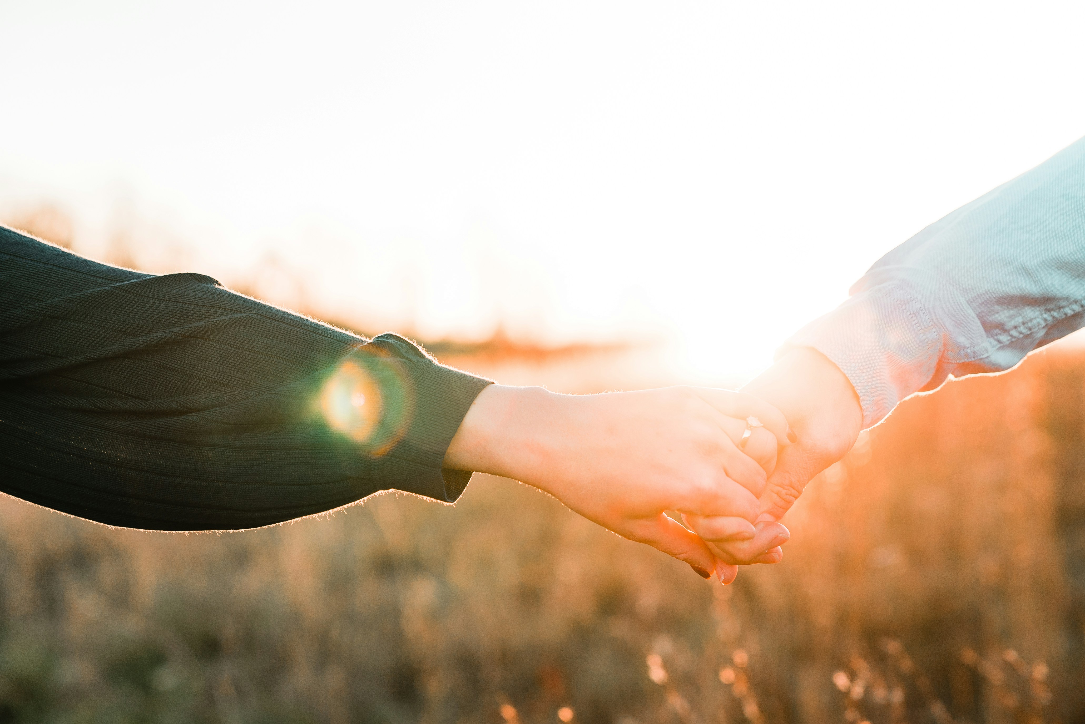 Image of 2 hands reaching to eachother.